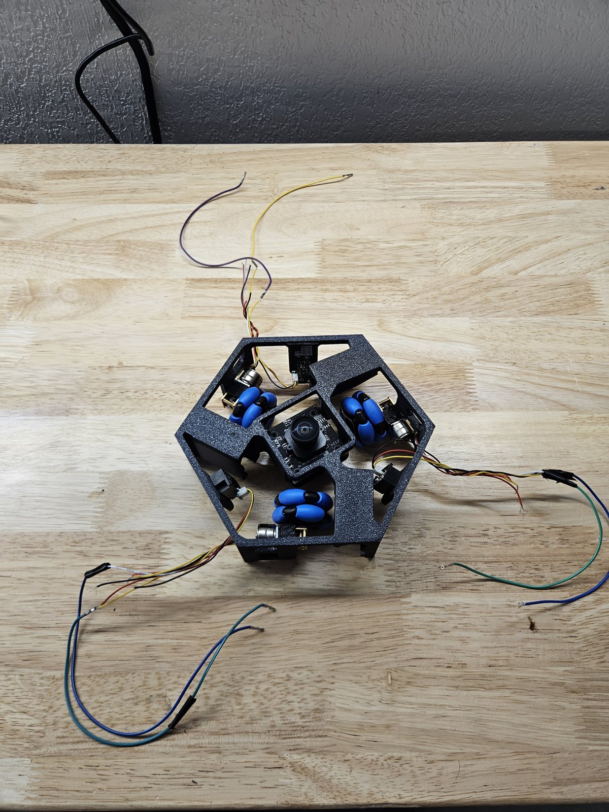 3D-printed hexagonal chassis with three motor mounts and wiring